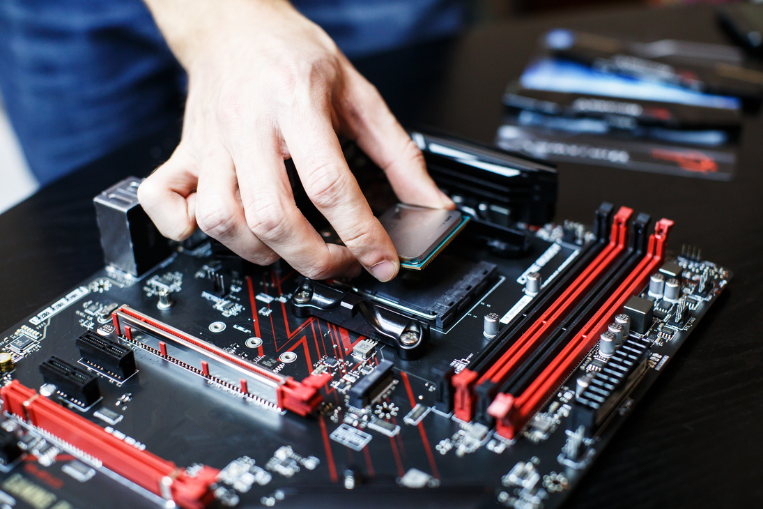 A man is assembling components to build a computer